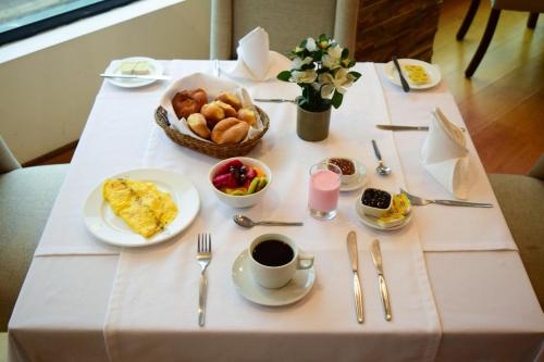 a table with breakfast foods and a cup of coffee at Hotel Miramar in Lima