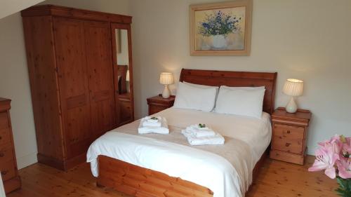 a bedroom with a bed with towels on it at Anchor Haven in Goleen