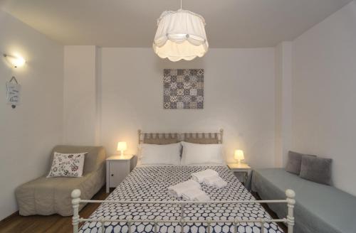 a bedroom with a bed and a couch and a chandelier at Affittacamere BB STEFY in Pisa