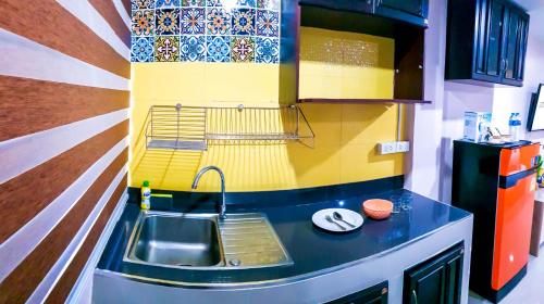 a small kitchen with a sink and a counter at Walking Street Residence - Boutique Suites near the Beach & Walking Street in Pattaya South
