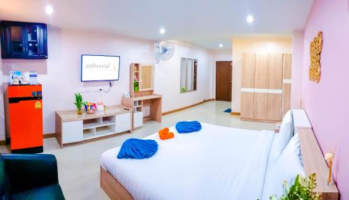 a room with a bed and a tv in it at Walking Street Residence - Boutique Suites near the Beach & Walking Street in Pattaya South