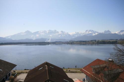 a view of a large body of water with mountains at Residenz Sonnenhang II in Füssen