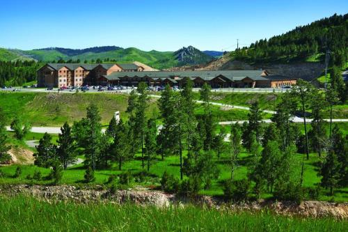 a field with trees in front of a building at The Lodge at Deadwood in Deadwood