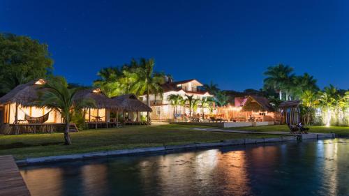 a resort at night with a body of water at Hotel CasaBakal - A pie de Laguna - Bacalar in Bacalar