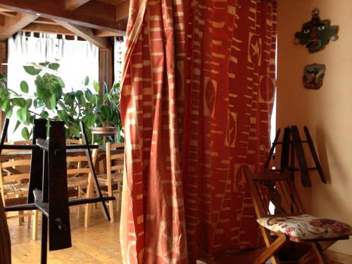 a room with a curtain and a table and chairs at Azienda Agricola Il Querceto in Marsico Vetere