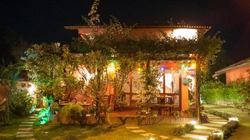 a house with christmas lights in front of it at Pousada Vila Rosada in Florianópolis