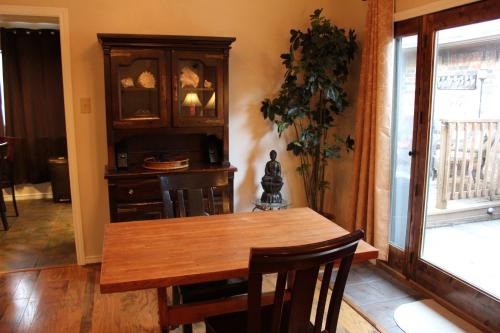 a dining room with a wooden table and a cabinet at Comfy Cozy Affordable Home Away Home in Garland