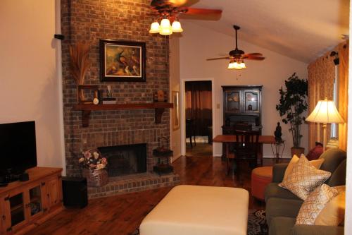 a living room with a brick fireplace and a couch at Comfy Cozy Affordable Home Away Home in Garland