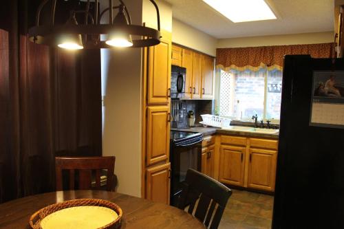 a kitchen with wooden cabinets and a table with a sink at Comfy Cozy Affordable Home Away Home in Garland