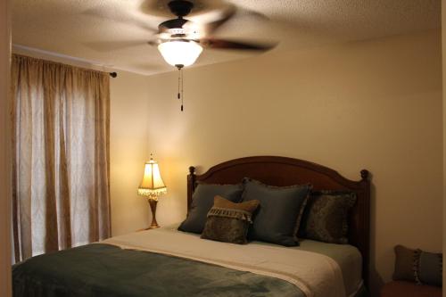 a bedroom with a bed with a ceiling fan at Comfy Cozy Affordable Home Away Home in Garland