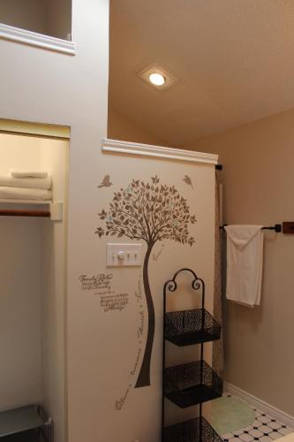 a bathroom with a tree stenciled on the wall at Comfy Cozy Affordable Home Away Home in Garland