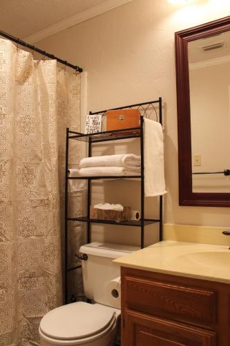 a bathroom with a toilet and a sink at Comfy Cozy Affordable Home Away Home in Garland