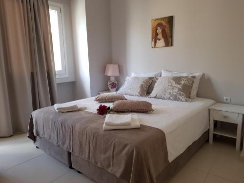 a bedroom with a large bed with two towels on it at Heraklion Old Port Apartments in Heraklio