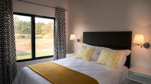 a bedroom with a bed and a large window at The Urban Hotel Ndola in Ndola