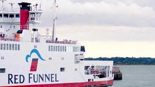 a ferry boat is docked in the water at room2 Southampton Hometel in Southampton