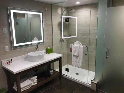 a bathroom with a sink and a shower at Wyndham Anaheim in Anaheim