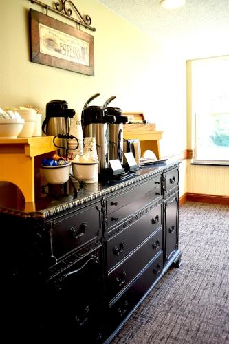 a black stove with pots and pans on top of it at Country Inn River Falls in River Falls