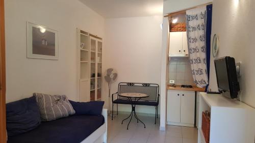 a living room with a couch and a small table at Residenze Coda Cavallo in San Teodoro