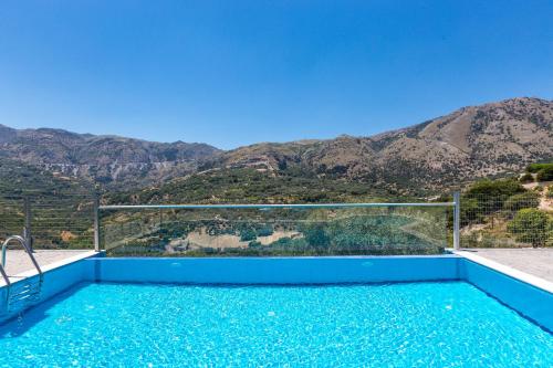 a swimming pool with a view of the mountains at Villa Asigonia with Heated Pool & Whirlpool in Asigonía