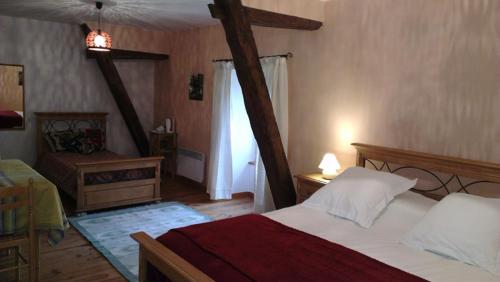 a bedroom with a large bed and a window at La Ciboulette in Foix