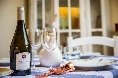 a bottle of wine sitting on a table with glasses at Apartmán U Mluvících Kamenů in Staré Křečany