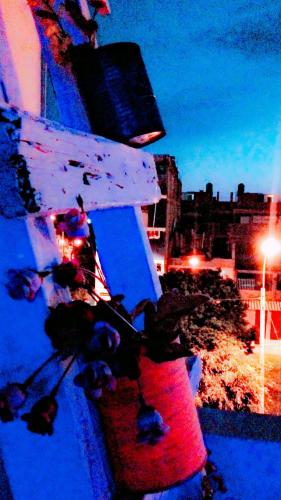 a group of people sitting on a ledge at night at La Casa del Che Fernando in Lima
