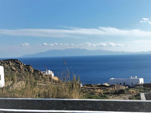 a view of the ocean from the side of a hill at Mando Pool Villas w Sea Views - Five Bedrooms in Super Paradise Beach