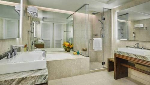 a bathroom with a tub and a sink and a shower at Four Seasons Resort Oahu at Ko Olina in Kapolei