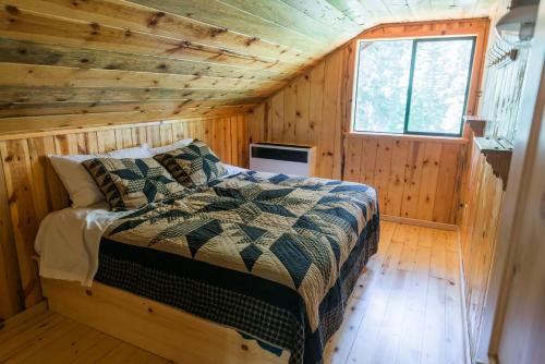a bedroom with a bed in a wooden cabin at Silver City Mountain Resort in Sequoia National Park