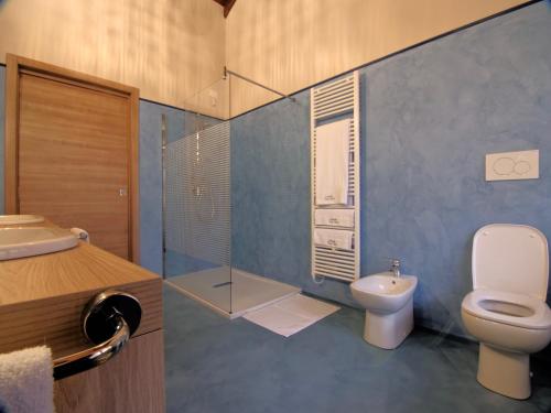 a bathroom with a toilet and a glass shower at Locanda Papà Nenè in Osnago