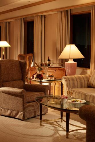 a living room with a couch and a table at Hotel Hamatsu in Koriyama