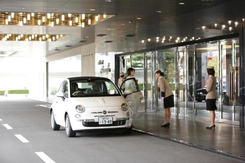 a small white car parked inside of a building at Hotel Hamatsu in Koriyama