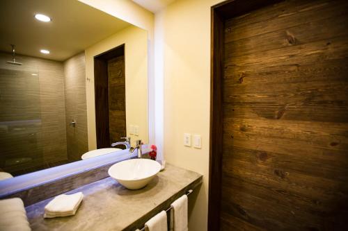 a bathroom with a sink and a mirror at Casa de la Ballena in Sayulita