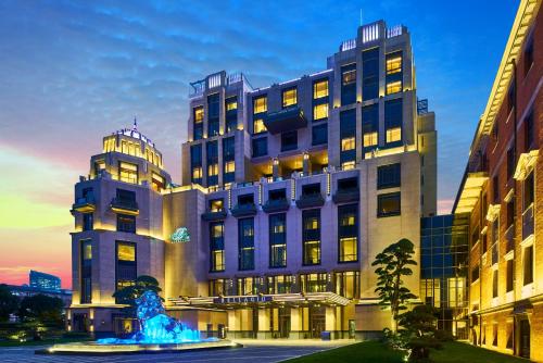 a large building with a fountain in front of it at Bellagio by MGM Shanghai - on the bund in Shanghai