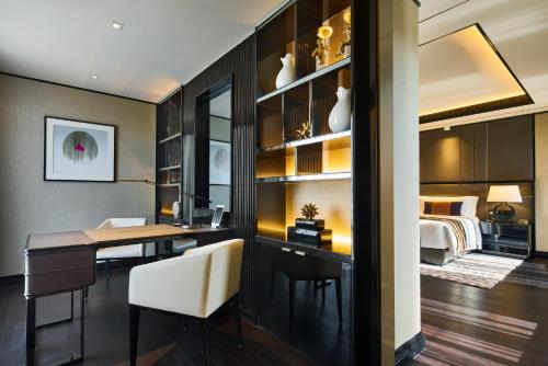 a dining room with a desk and a bedroom at Bellagio by MGM Shanghai - on the bund in Shanghai