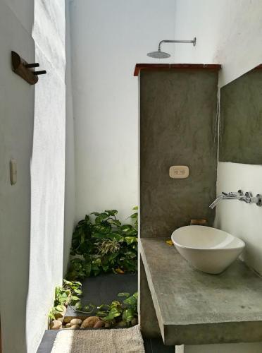 a bathroom with a bowl sink on a counter at La Casa de Hercilia Boutique in Barichara