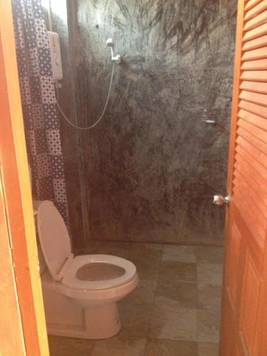 a bathroom with a toilet and a shower at Milin Guesthouse in Chiang Rai