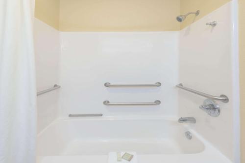 a bathroom with a bath tub with two handles at Super 8 by Wyndham Martinsville in Martinsville