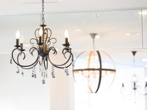 a chandelier hanging from a ceiling in a room at Hotel AreaOne Sakaiminato Marina in Sakaiminato