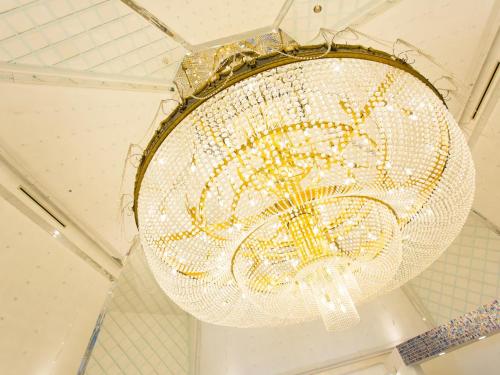 a large crystal chandelier hanging from a ceiling at Hotel AreaOne Sakaiminato Marina in Sakaiminato