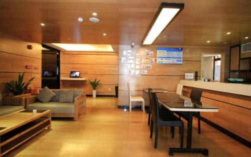 a living room with a table and a couch at Lavande Hotel Zhuhai Gongbei Port Square in Zhuhai
