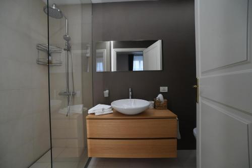 a bathroom with a sink and a shower at Lainez Rooms & Suites in Trento