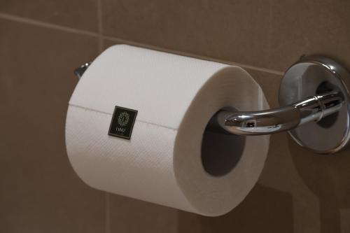 a roll of toilet paper on a holder in a bathroom at Lainez Rooms & Suites in Trento