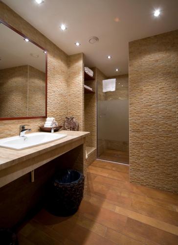 a bathroom with a sink and a shower at Boutique Hotel Victoria Budapest in Budapest