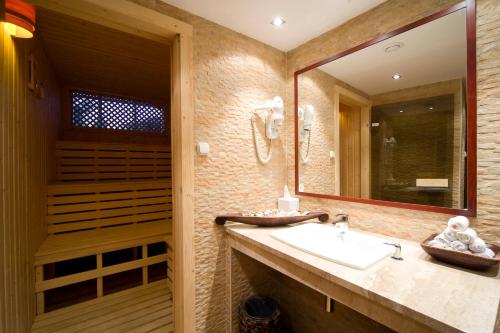 a bathroom with a sink and a mirror at Boutique Hotel Victoria Budapest in Budapest