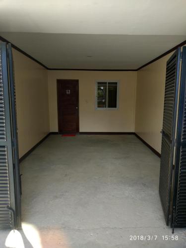 a large empty room with a door and a room with a room at Bicotels Hotel in Batangas City