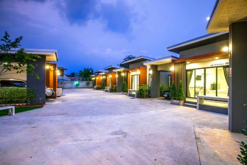 a row of houses at night with lights at Baan Le Vimaan in Nakhon Ratchasima