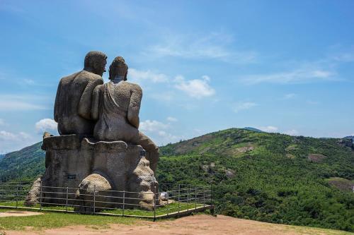 a statue of a couple sitting on top of a mountain at Skyrock Inn in Kattappana