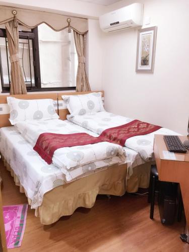 two beds sitting next to each other in a room at Hong Kong Tai San Guest House (Harilela Branch) in Hong Kong