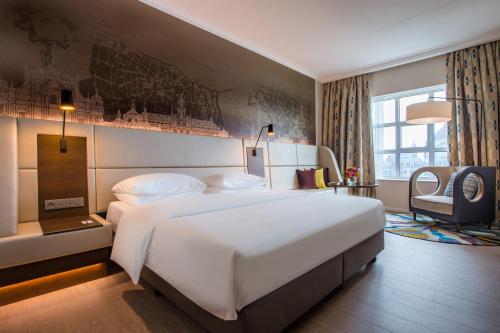 a large white bed in a hotel room at Radisson Blu Hotel, Antwerp City Centre in Antwerp